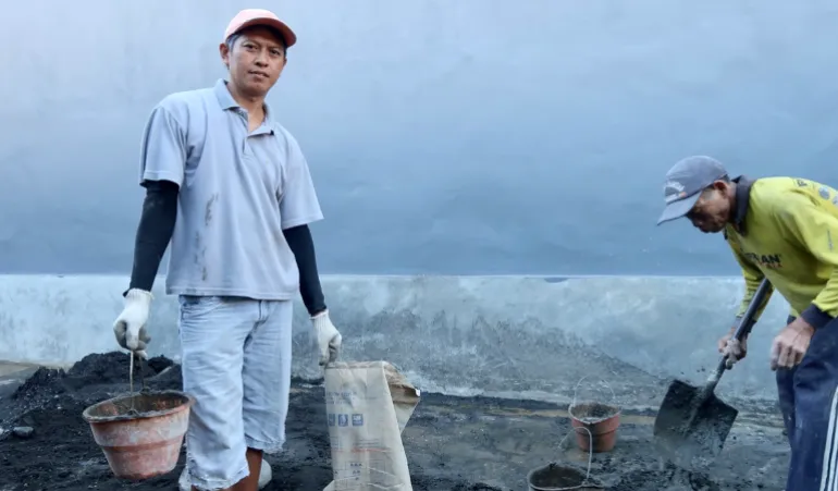 Komang Suarmika, a tourist guide for more than 17 years, is now working on a construction site to earn money after selling jewellery and other belongings to make ends meet [Erwin Pietersz/Al Jazeera